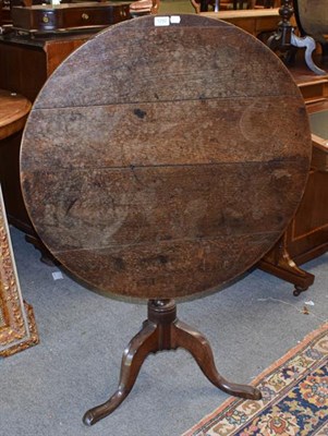 Lot 1292 - A George III oak tilt top tripod table, 83cm diameter by 72cm high