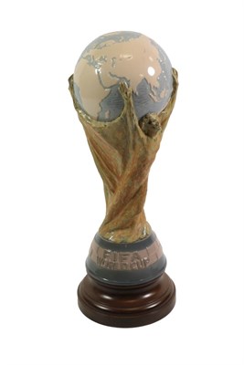 Lot 3006 - Lladro Model Of The Fifa World Cup designed by Bertoni of Italy, raised on turned wooden...