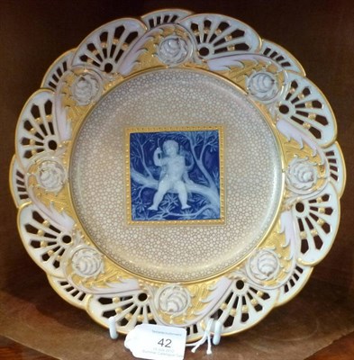 Lot 42 - A Minton Pâte-sur-Pâte Plate, dated 1902, by Alboine Birks, with Cupid sitting on  a branch...