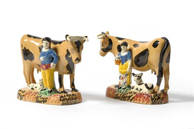 Lot 51 - A Pair of Pratt Type Pottery Cow Groups, circa 1810, each buff coloured beast with dark brown...