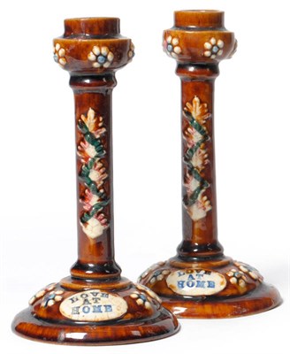 Lot 63 - A Pair of Measham Pottery Bargeware Candlesticks, late 19th century, with semi-ovoid sconces, plain