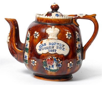 Lot 64 - A Measham Pottery Bargeware Commemorative Teapot and Cover, dated 1887, of ovoid form, applied with