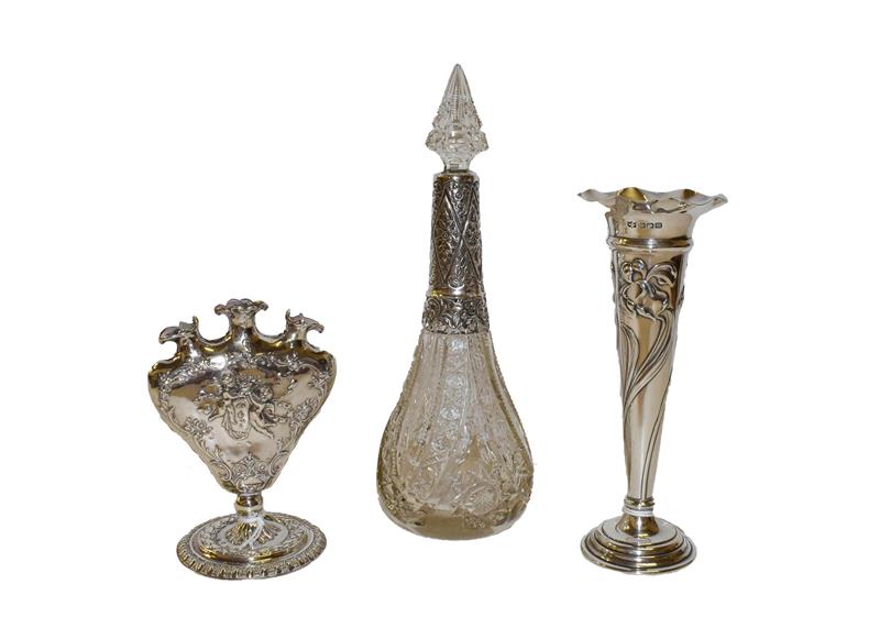 Lot 3 - Two silver vases and a silver-mounted glass bottle, one vase by Mappin and Webb, Sheffield...