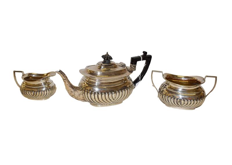 Lot 6 - A three-piece Victorian silver tea-service, London, 1895, each piece with part-fluted lower...