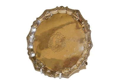 Lot 7 - A George III silver waiter, by Ebenezer Coker, London, 1766, shaped circular and on three ball...