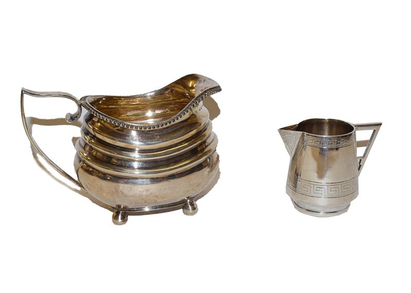 Lot 29 - A George III silver milk jug, probably by Solomon Hougham, London, 1795, 14cm long, together with a