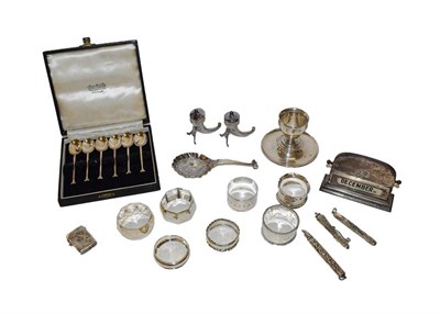 Lot 42 - A collection of assorted silver, including six various napkin rings, a cup on stand, a pair of...