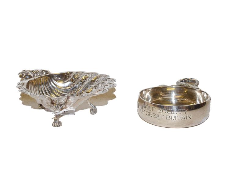 Lot 44 - An Elizabeth II silver wine taster and a shell shaped dish (2)