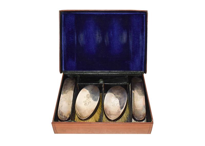 Lot 46 - A set of four silver brushes, William Comyns, London 1910, in a fitted leather case, engraved...