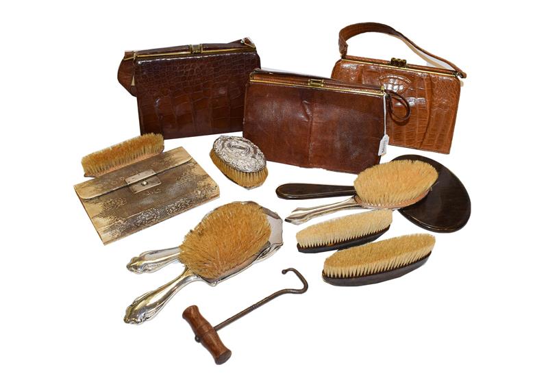 Lot 89 - A snakeskin manicure case with mother of pearl fittings, a silver backed hand mirror and brush,...