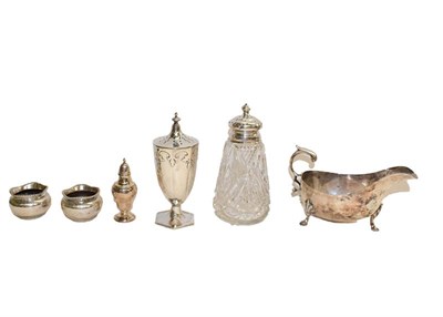 Lot 104 - A collection of assorted silver, comprising a sauce boat, a caster with applied cut-card...