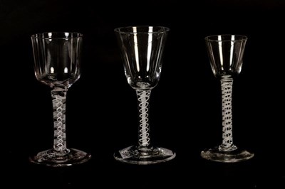 Lot 174 - Three Georgian wine glasses raised on double series opaque twist stems (3)