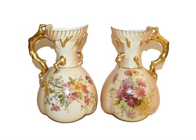 Lot 177 - A pair of Royal Worcester ewers date code 1899, painted with flowers to a blush ground with...
