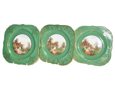 Lot 179 - Three Royal Worcester plates with gilded and green ground edge the centre painted with cottage...