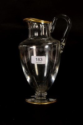 Lot 183 - A Baccarat glass jug, with flat cut collar, etched band of daisy heads, gilt rims and a gilt crest