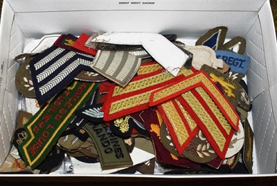 Lot 219 - A quantity of post second world war cloth insignia, mainly British and including rank stripes...