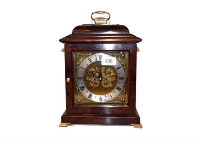 Lot 236 - A modern mahogany cased table clock on brass bracket feet, with 6'' brass square dial having...