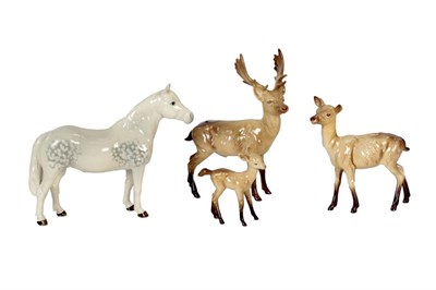 Lot 244 - Beswick Connemara pony, grey gloss together with Beswick stag, doe and fawn (a.f.) (4)