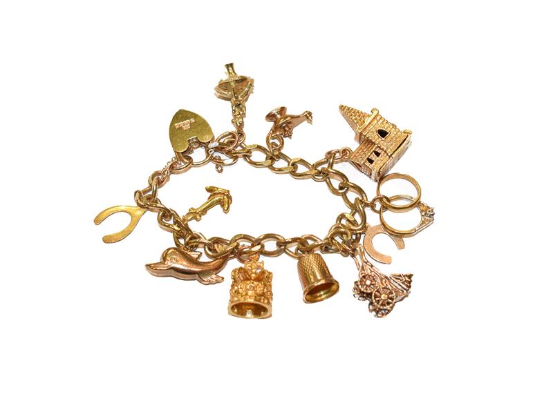 Lot 322 - A 9 carat gold charm bracelet, hung with various charms including a thimble, a dolphin, a pram,...