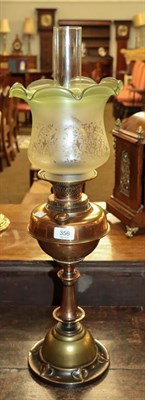 Lot 356 - An Art Nouveau brass based oil lamp with etched glass shade, 72cm overall