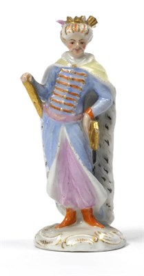 Lot 118 - A Meissen Porcelain Miniature Model of a Turk, mid 18th century, standing wearing a long cloak...