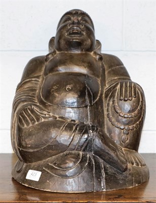 Lot 423 - A 19th century carved wooden Buddha, 40cm high