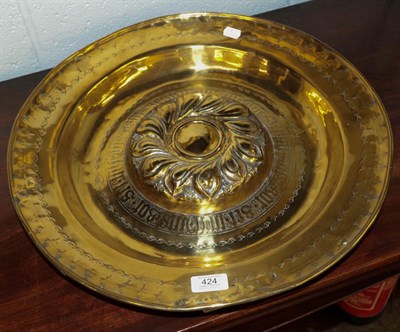 Lot 424 - A 16th/17th century Nuremburg brass alms dish with central ornate boss within a band of Gothic...