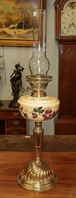Lot 426 - A Victorian brass based oil lamp with painted glass resivoir chimney, 46cm not including chimney