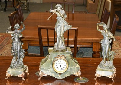 Lot 463 - A green onyx and spelter figural striking mantle clock with garniture