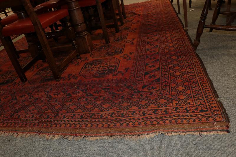 Lot 1081 - Afghan Ersari Carpet, the madder field with columns of 'elephant foot' guls enclosed by stellar...