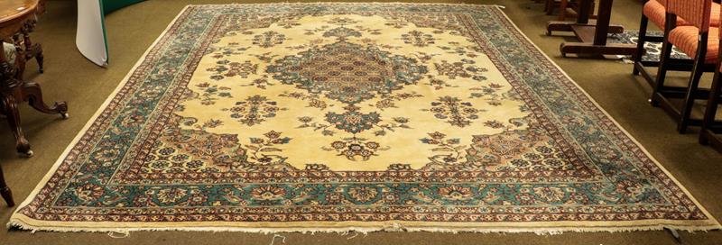 Lot 1086 - A large Oriental carpet, probably Isparta, the ivory field with floral sprays around a...