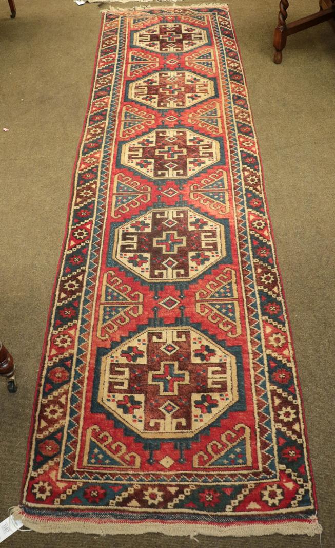 Lot 1087 - Dosemalti Runner, the soft raspberry field with a column of octagons framed by polychrome...