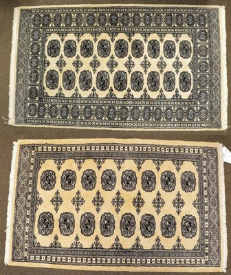 Lot 1091 - A Kashmiri 'Bukhara' Rug, the ivory field with columns of guls enclosed by narrow borders,...