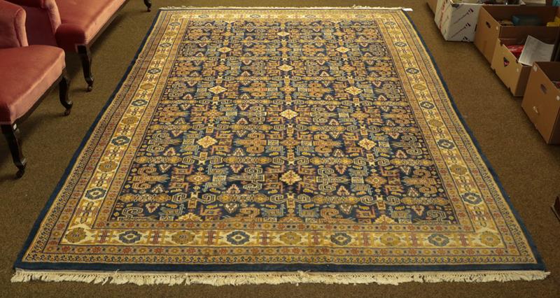 Lot 1093 - Indian rug of Perepdil design, the indigo field of rams horn motifs and flower heads enclosed...