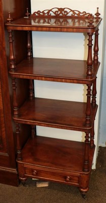 Lot 1106 - A Victorian mahogany four-tier whatnot stand with fretwork pediment, turned supports and a...