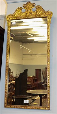 Lot 1107 - A giltwood and gesso wall mirror with swan neck pediment and Prince of Wales feathers motif,...