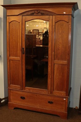 Lot 1111 - An Edwardian oak mirror front single door wardrobe, 130cm by 46cm by 208cm