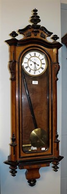 Lot 1112 - A Vienna type walnut veneered double weight striking wall clock circa. 1890, 127cm high