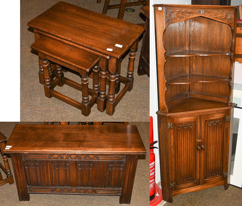 Lot 1113 - A Mellowcraft oak nest of three occasional tables, blanket box and corner cupboard (3)