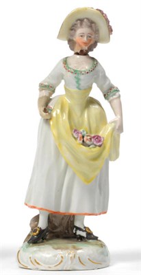 Lot 136 - A Frankenthal Figure of a Girl, circa 1777, standing wearing a floral hat, holding flowers in...