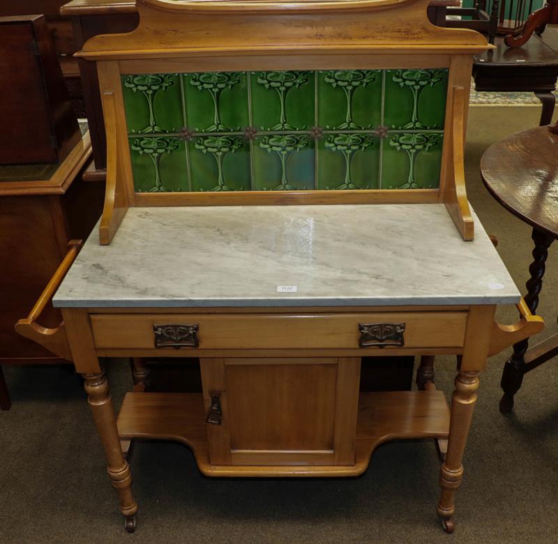 Lot 1122 - A Victorian satin-wood marble-topped washstand with Art-Noveau tiled splash back, 110cm by 46cm...