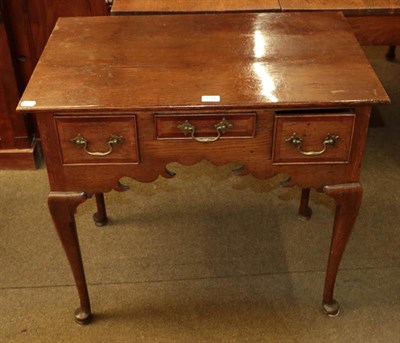 Lot 1144 - An 18th century style oak lowboy, the front with three small drawers and pad shaped feet, 80cm...