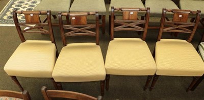 Lot 1149 - A set of four Regency inlaid mahogany dining chairs raised on turned supports and with...
