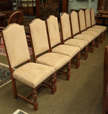 Lot 1156 - A set of eight 20th century oak dining chairs upholstered in stone suede studded fabric (8)