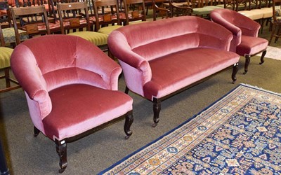 Lot 1157 - A Edwardian mahogany framed three-part parlour suite, upholstered in blush pink velvet...