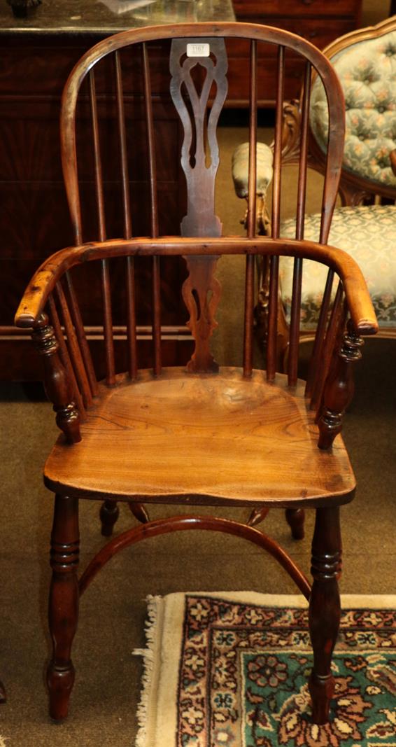 Lot 1167 - A 19th century yew wood and ash Windsor armchair with crinoline stretcher