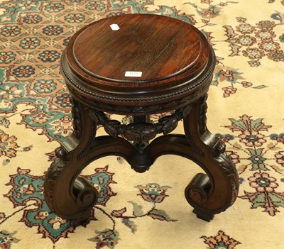 Lot 1171 - An early 20th century oak and walnut jardiniere stand riased on carved scroll supports and with...