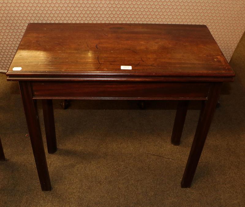 Lot 1173 - A George III mahogany fold-over tea table raised on reeded square supports, 82cm by 40cm by 73cm