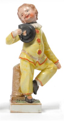 Lot 141 - A Frankenthal Porcelain Figure of Pierrot, 1783, standing on one leg wearing a yellow costume...