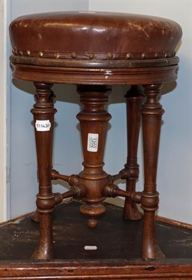 Lot 1202 - A Victorian mahogany rise and fall piano stool, raised on turned supports and with X frame...